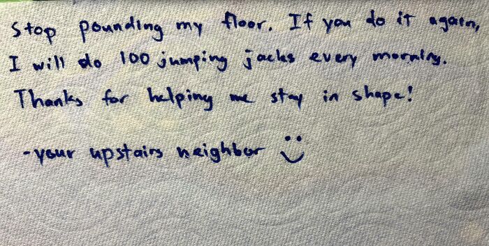 A funny neighbors note on a paper towel, threatening 100 jumping jacks if the floor pounding continues.