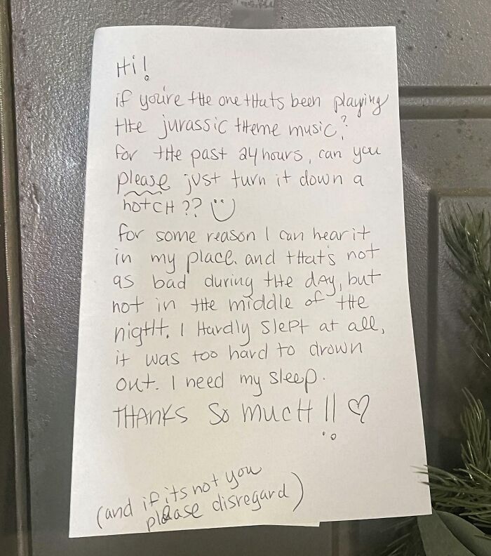 A handwritten funny neighbors note asking to turn down the Jurassic Park theme music.