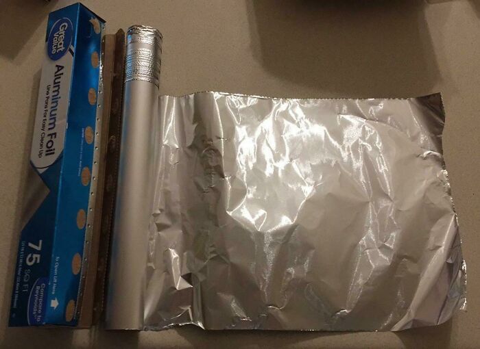 An open box of aluminum foil, with a roll of foil extending from it, illustrating horrible roommates.