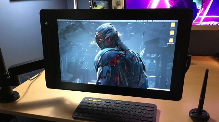 A black drawing tablet displaying a robot, with a keyboard and stylus nearby, an excellent Prime Day electronics deal.