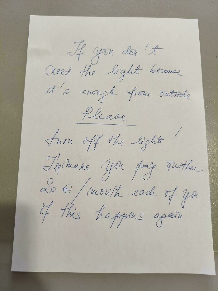 A handwritten note from a horrible landlord threatening to charge tenants an extra 20€/month for leaving lights on.