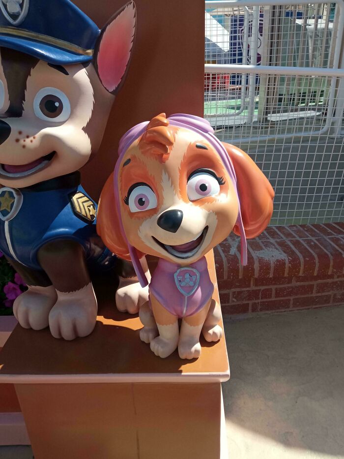 A creepy Paw Patrol character statue, a design fail that makes people feel uncomfortable, with an unsettling smile and wide eyes.