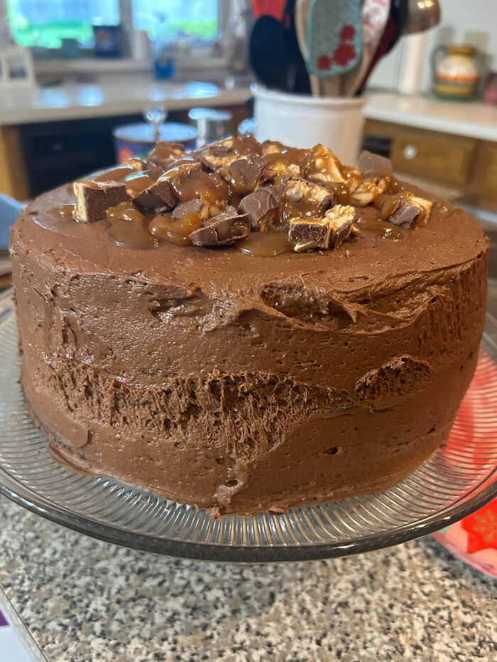 A chocolate cake with Snickers candy on top, a delicious treat not a design fail.