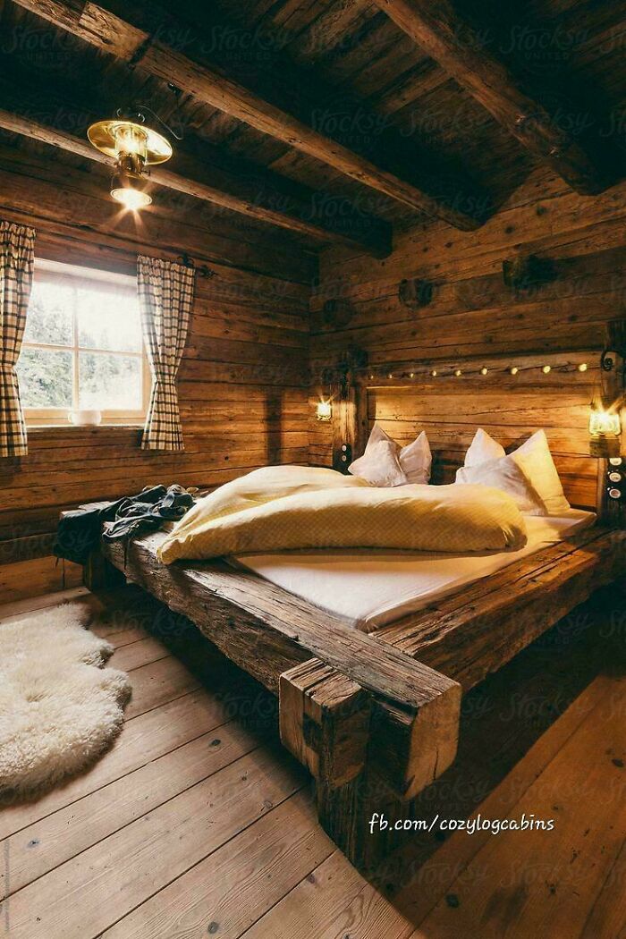 A cozy wooden cabin bedroom, with a bed made of logs, fluffy pillows, and warm lighting, no design fails here.
