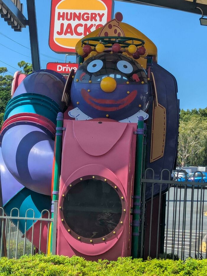 A creepy clown-faced play structure at Hungry Jack's, an unsettling design fail making people feel uncomfortable.