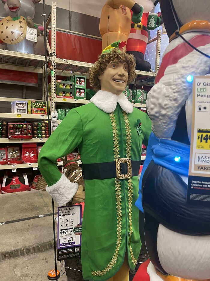 An animatronic of Buddy the Elf standing in a store aisle, a creepy design fail that makes people feel uncomfortable.