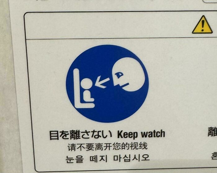 A blue and white sign depicting a person watching another persons head, a creepy design fail with text.