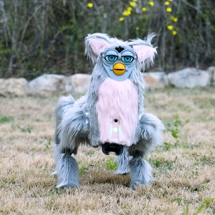 A creepy robotic creature resembling a furby in a garden, a design fail that makes people feel uncomfortable.