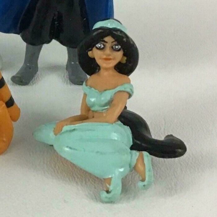 A deformed Princess Jasmine figurine, a creepy design fail that makes people feel uncomfortable with its odd look.