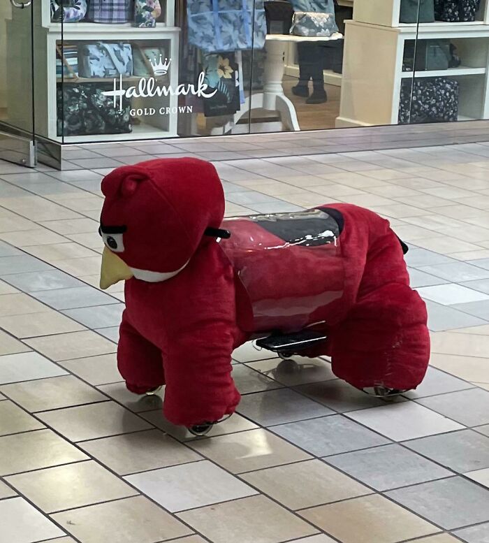 A red Angry Birds character ride-on toy, a creepy design fail in a mall.