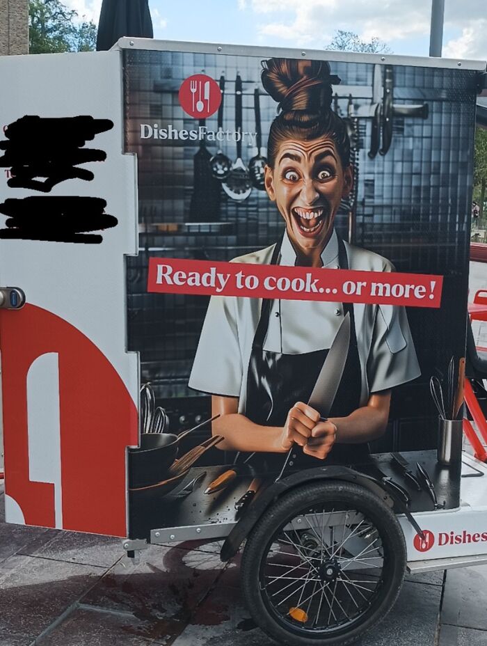 A food cart with a chef holding a knife with a creepy expression, a design fail.