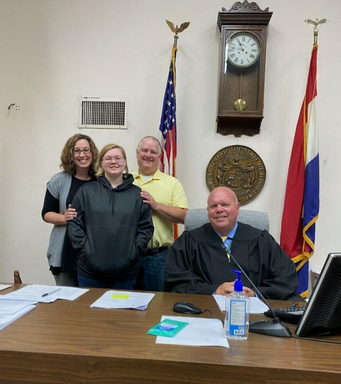 A family and a judge celebrating an adoption, showing how families choose each other.