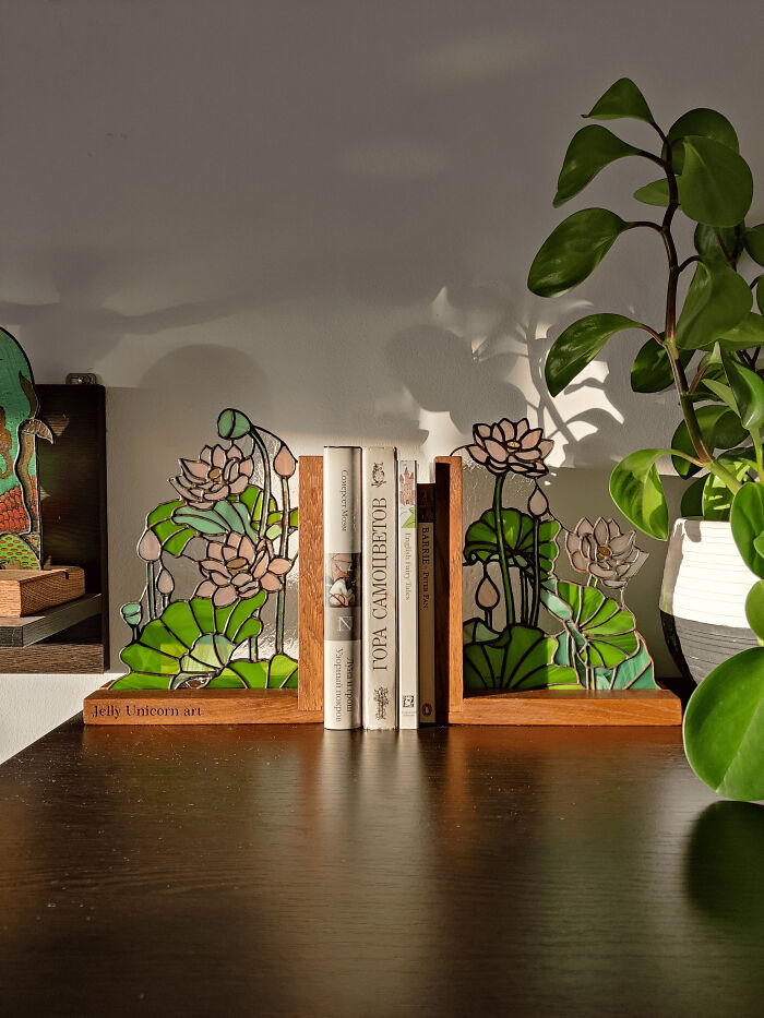 A pair of beautiful handmade lotus flower bookends holding books, showcasing talent and patience.