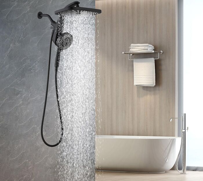 A modern black showerhead spraying water in a stylish bathroom, featuring home finds on sale.