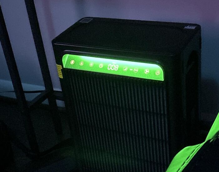 A glowing green display on a black home air purifier, one of the top home finds on Prime Day.