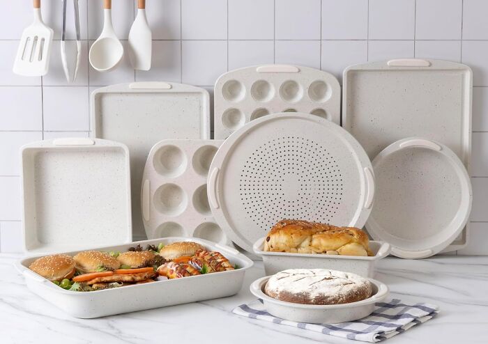 A collection of white baking dishes and pans, some filled with food, among the kitchen finds for Prime Day.