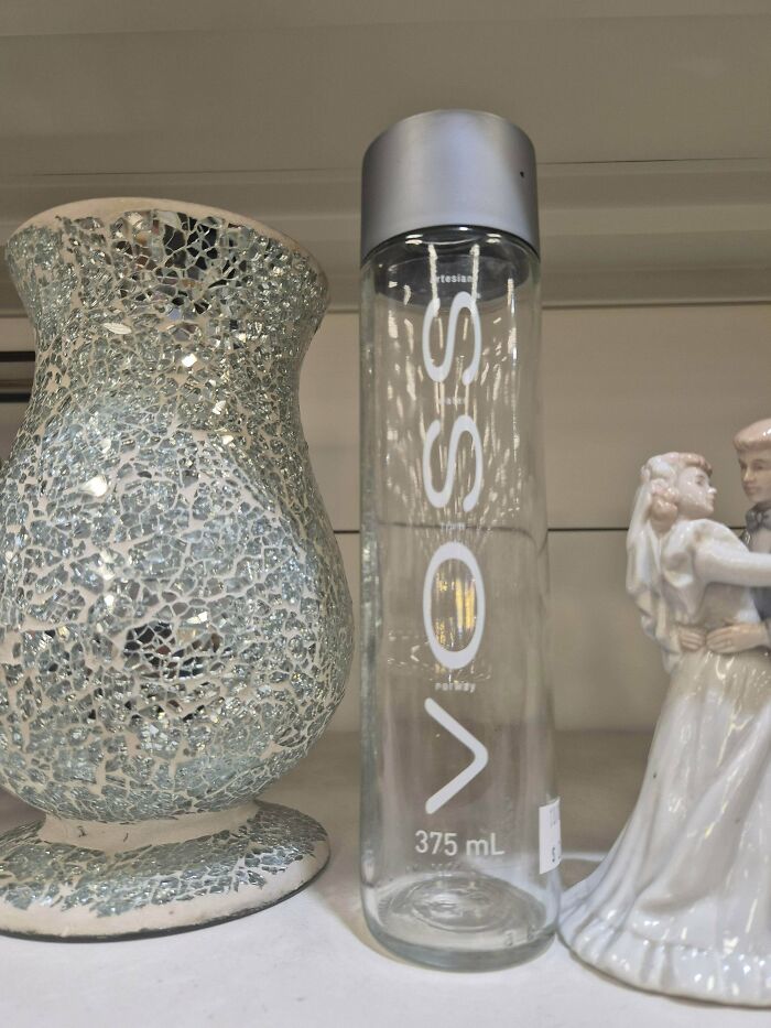 A Voss water bottle next to a decorative mosaic vase, an interesting post that might resonate with an Aussie.