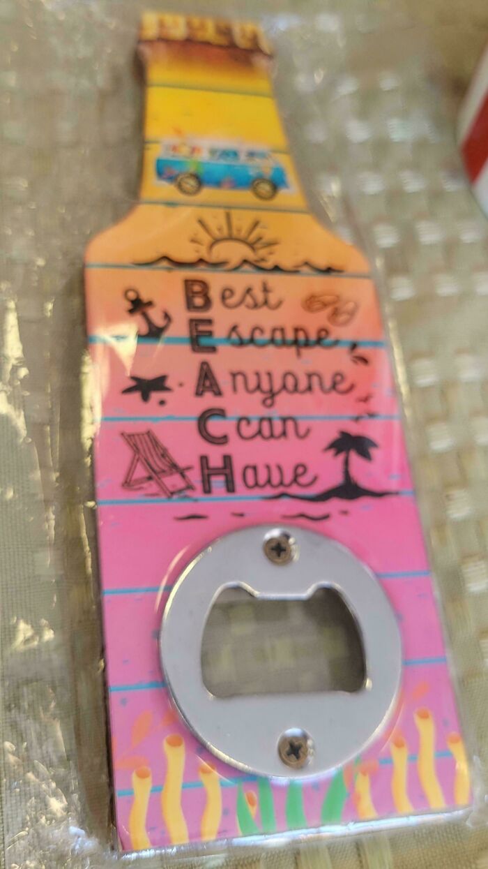 Funny fails: A bottle opener with a beach theme and an unfortunate typo in the word BEACH.