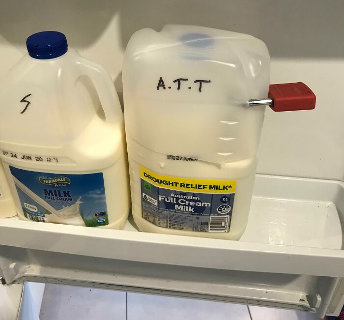 Two milk cartons, one with a lock and AT.T written on it, highlighting issues with horrible roommates and food theft.