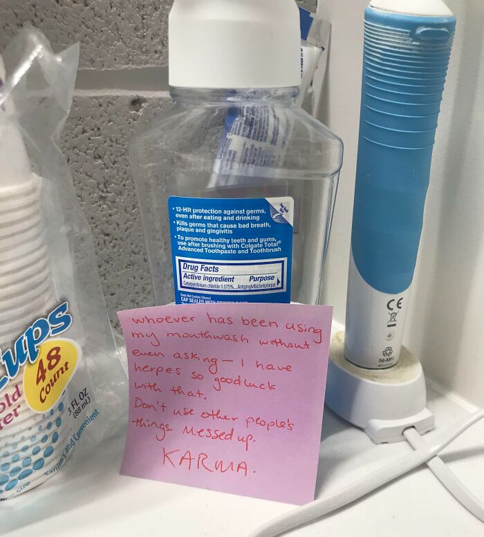 A sticky note on a mouthwash bottle, revealing a horrible roommate's unsanitary habit of using shared items.