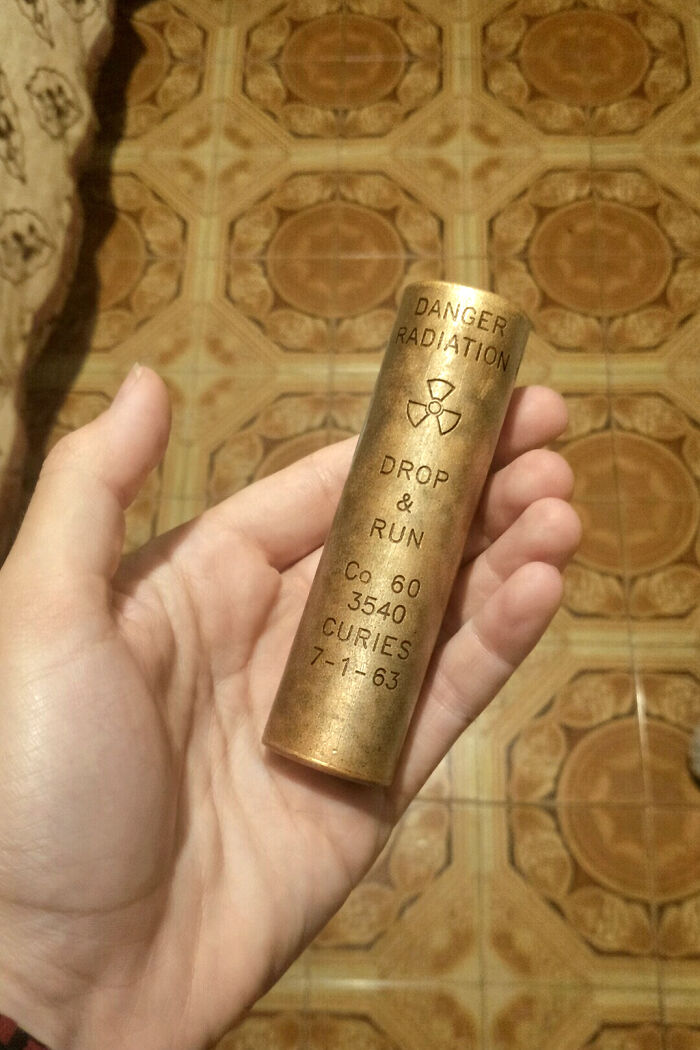 A hand holding a radioactive cylinder, illustrating things that should be left alone.
