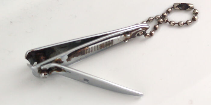 A rusty, old nail clipper with a keychain, a thing that should really be left alone.