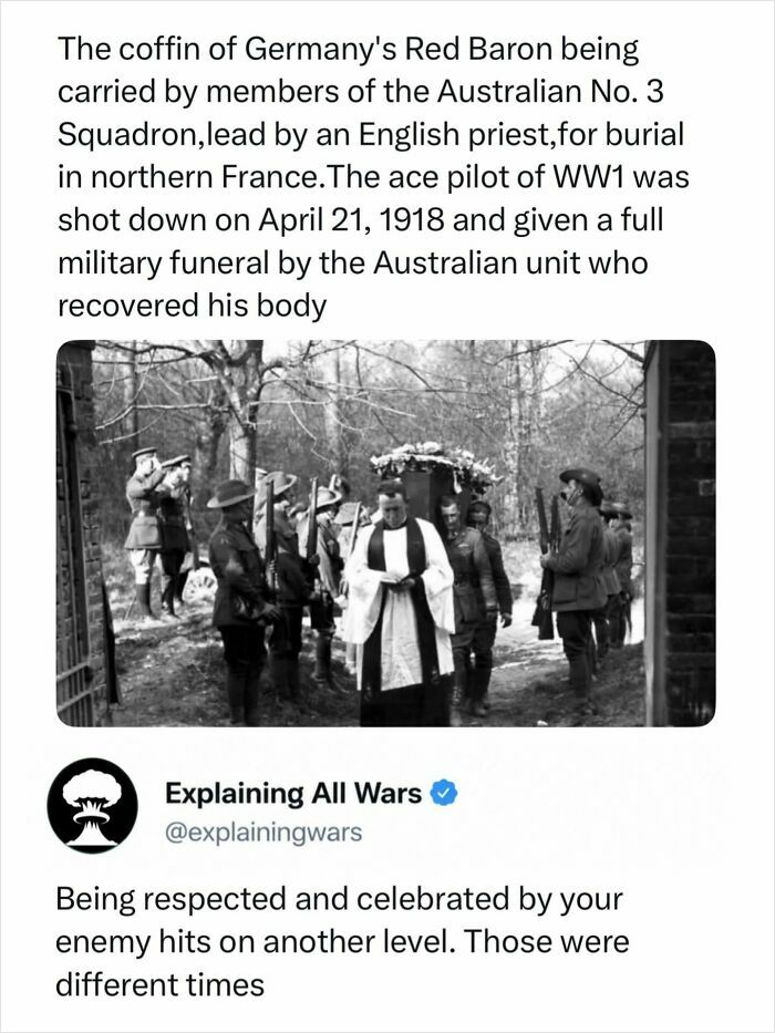 Black and white image of the Red Baron's coffin carried by Australian soldiers and an English priest, explaining all wars.