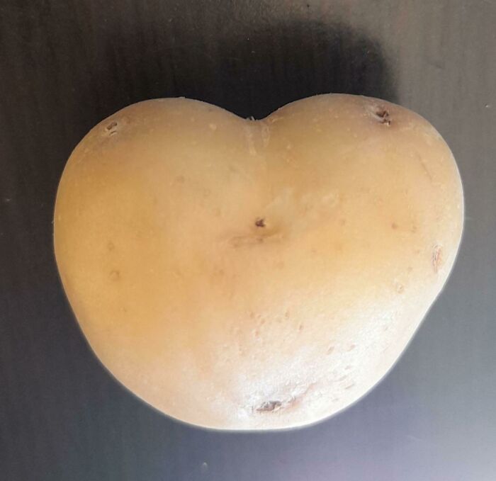 A heart-shaped potato, a wholesome and unusual thing found in nature.