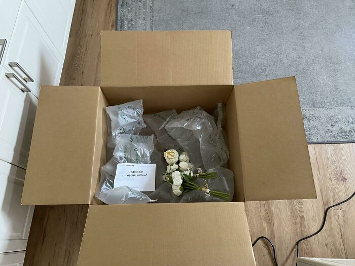 A delivery fail with a large box containing minimal items and excessive packing material, leading to laughter or crying.