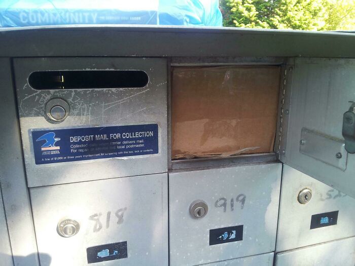 A big brown package stuffed into a small mailbox compartment, a clear delivery fail.