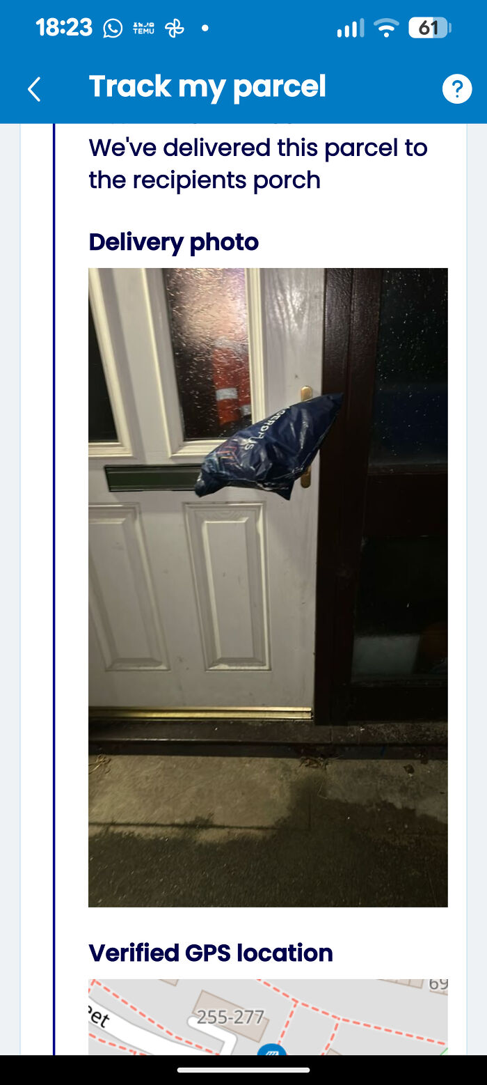 A black plastic bag, a delivery fail, hanging from a doorknob, displayed on a parcel tracking app.