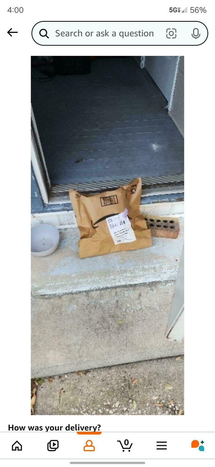 A brown package sits incorrectly on a step, illustrating a delivery fail.