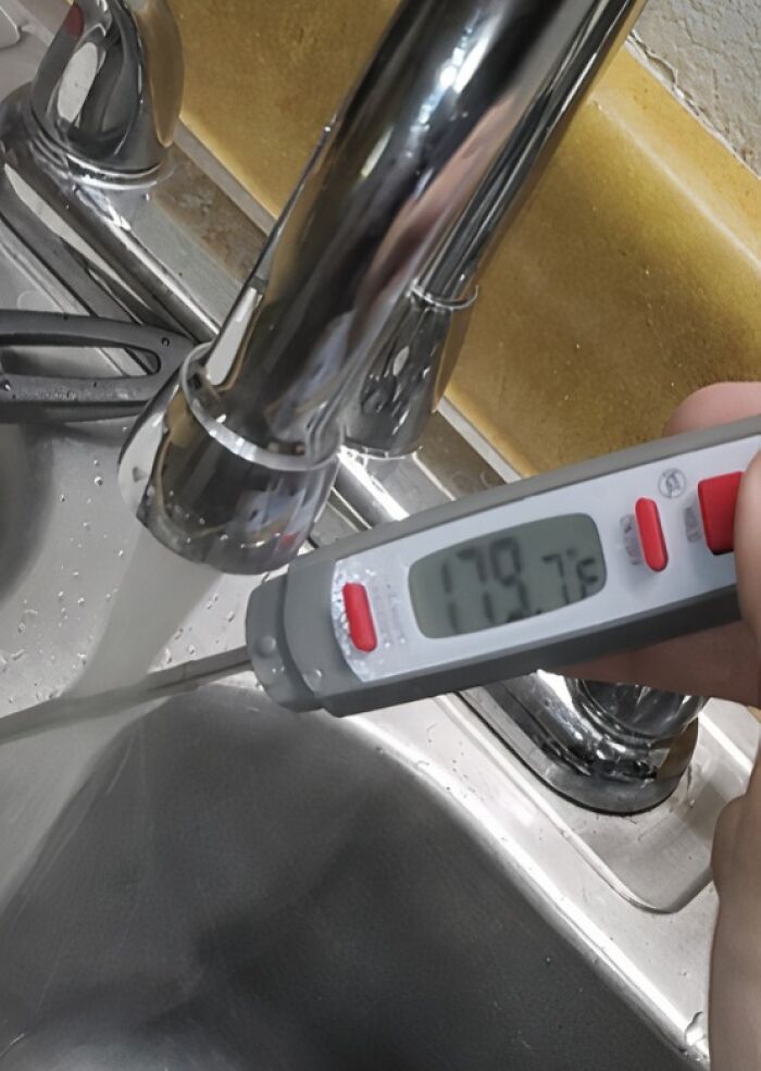 A thermometer shows water at 179.7 degrees Fahrenheit, representing a horrible landlord's maintenance issue.