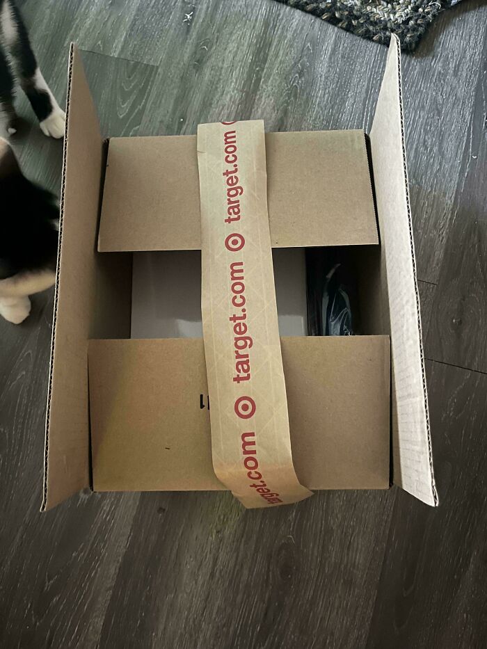 An opened cardboard box with Target tape, showing a small package inside, illustrating delivery fails.