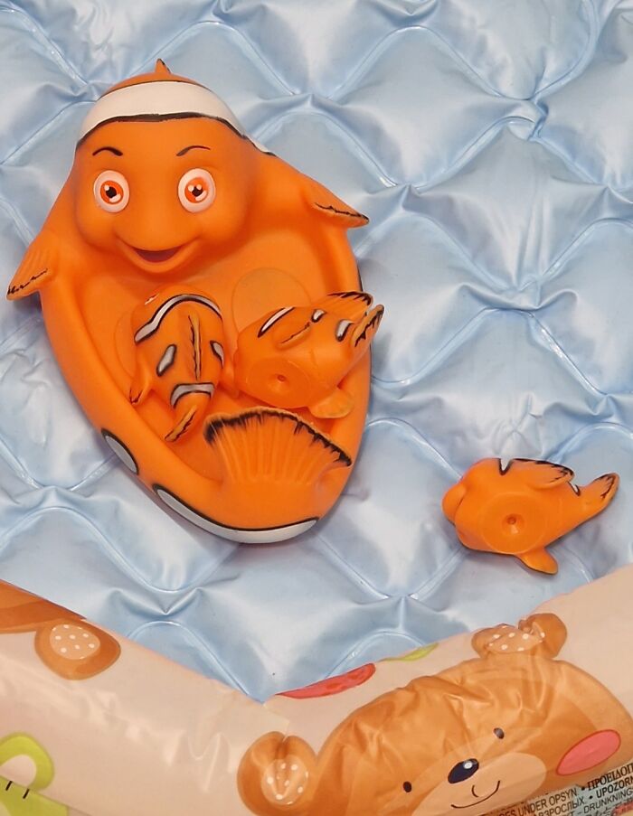 A creepy, orange clownfish toy with small baby fish inside, a design fail.