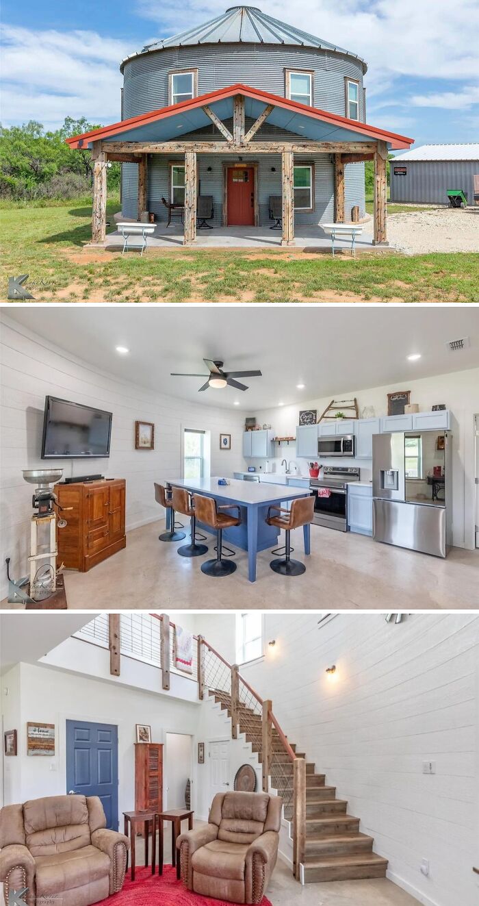 A round, silo-like unusual home with a rustic front porch, showcasing its modern open-plan kitchen-living area and a wooden staircase.