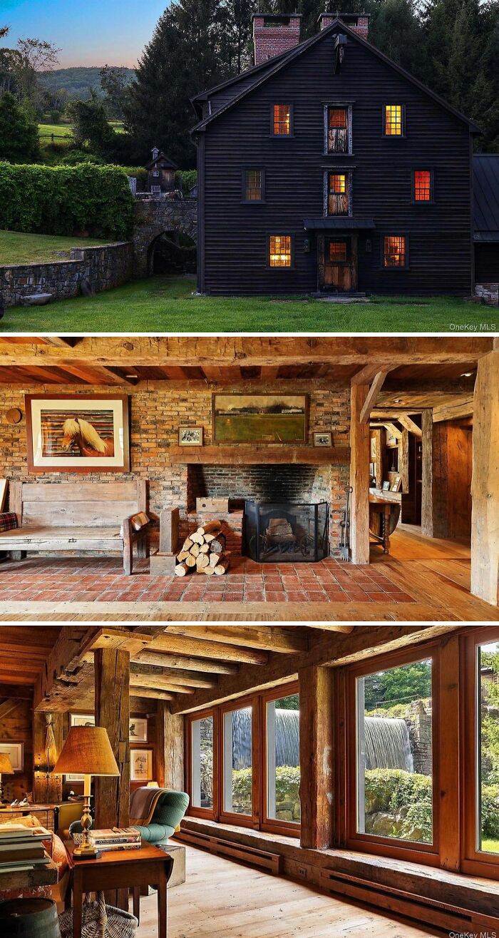 A cool and unusual dark-colored home with a rustic interior featuring brick, wood beams, and large windows.