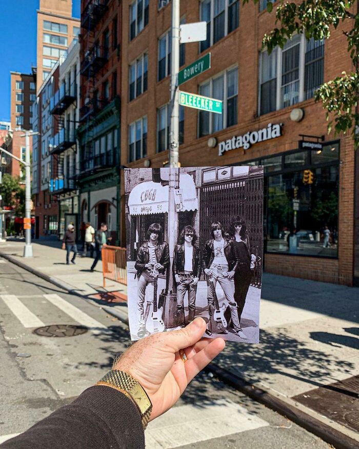 Hand holding a historic photo of the Ramones in front of CBGB on Bleecker and Bowery streets, showing how much America has changed.