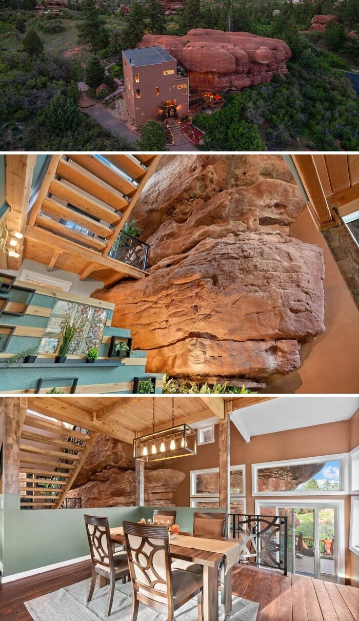 An aerial view of an unusual home, a house built into red rock formations, featuring a dramatic rock wall interior and dining area. Cool homes.