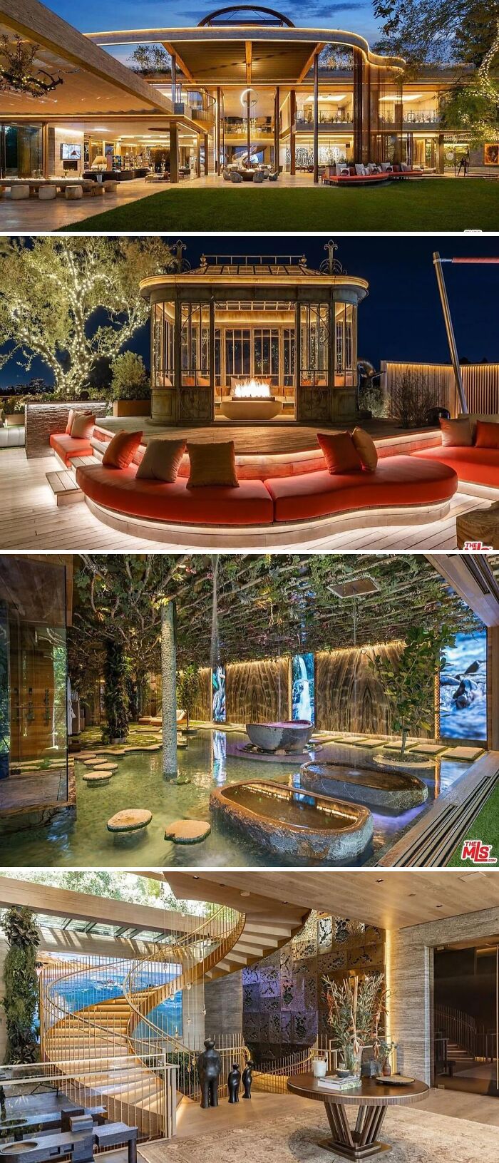 A modern, cool, wacky, and unusual home at night, showcasing a lit exterior, an outdoor lounge with a fire pit, and an indoor water feature.