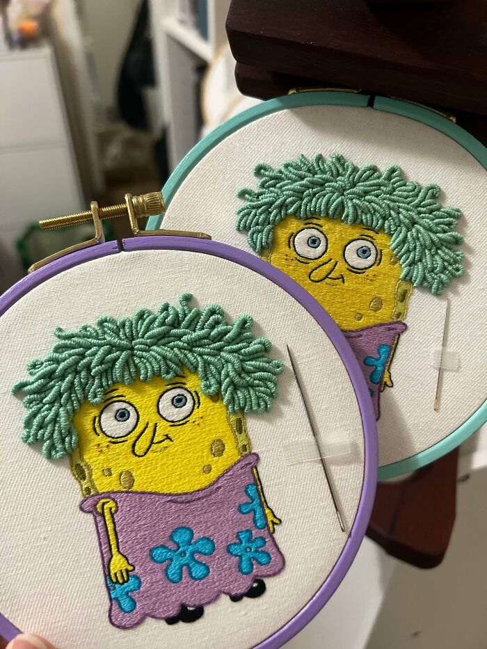 Detailed embroidery projects depicting cartoon characters in hoops with needles.
