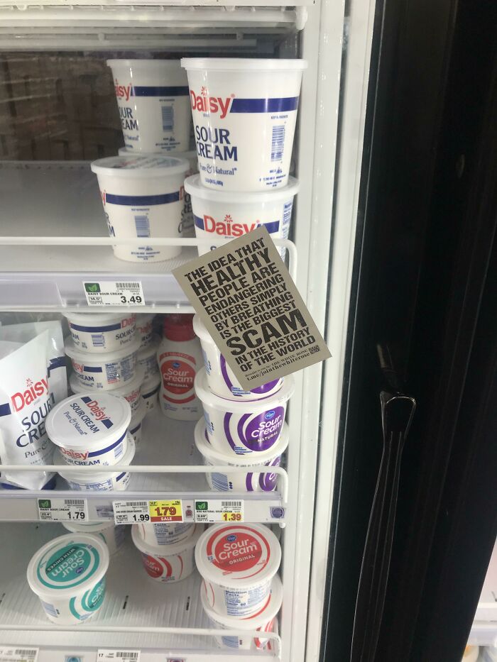 A flyer about a health scam placed in a refrigerated dairy case, challenging basic human decency.