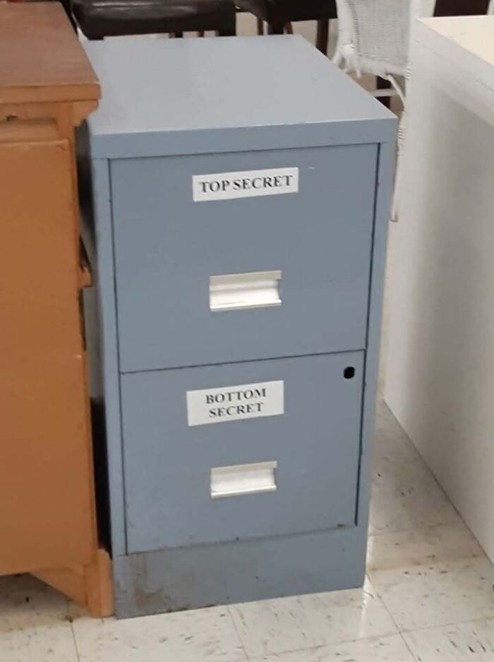 A filing cabinet with drawers labeled TOP SECRET and BOTTOM SECRET, illustrating a fever dream meme.