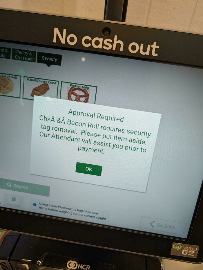 A self-checkout screen displaying an Approval Required message for a Bacon Roll, an interesting post about Aussie shopping.