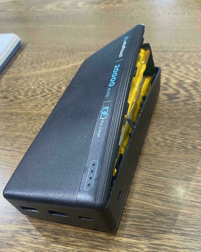 A swollen power bank with its casing split open, showing the internal heatwave damaged batteries, a survival challenge for Europeans.