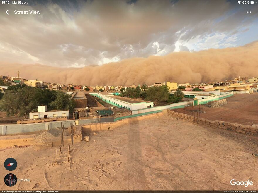 A massive sandstorm engulfing a city, captured in a bizarre Google Street View photo.