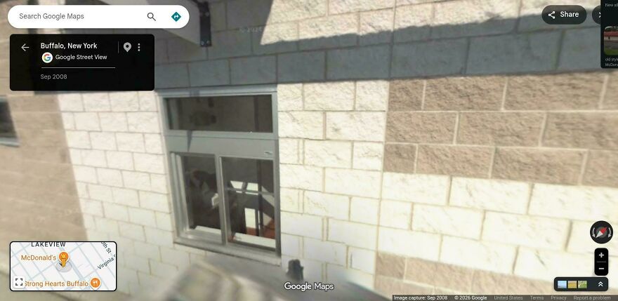 A reflection of a Google Street View car in a window, captured in a bizarre Google Street View photo.
