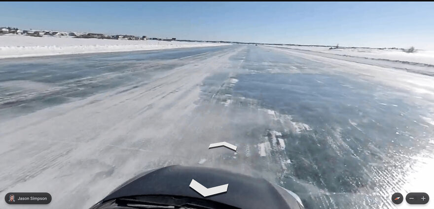 A bizarre Google Street View photo taken from a vehicle driving on an icy, snow-covered road.