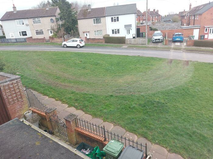 Tire tracks across a grassy area, illustrating a disregard for basic human decency by driving on the lawn.
