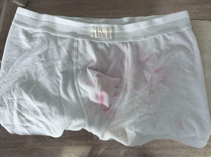 White boxer briefs with noticeable pink stains, illustrating a moment of questionable basic human decency.
